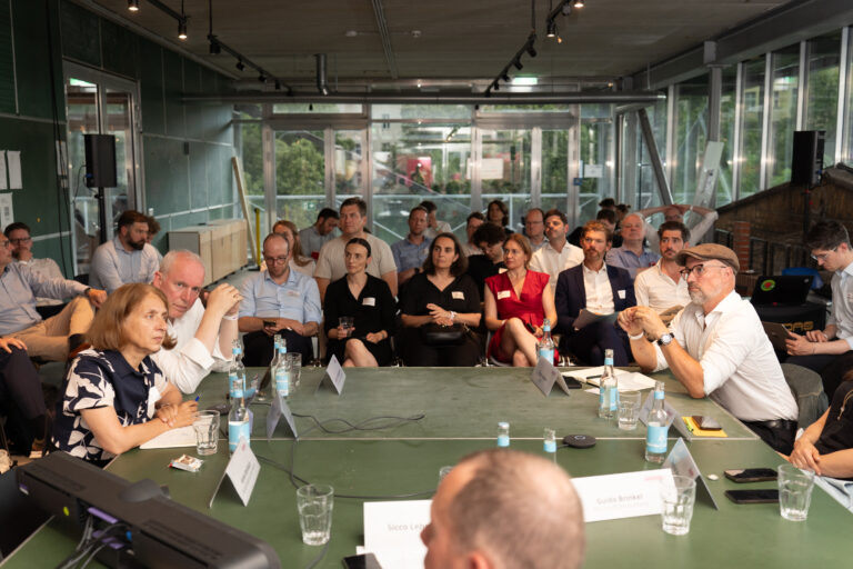Konferenzsetting mit Round Table und Publikum